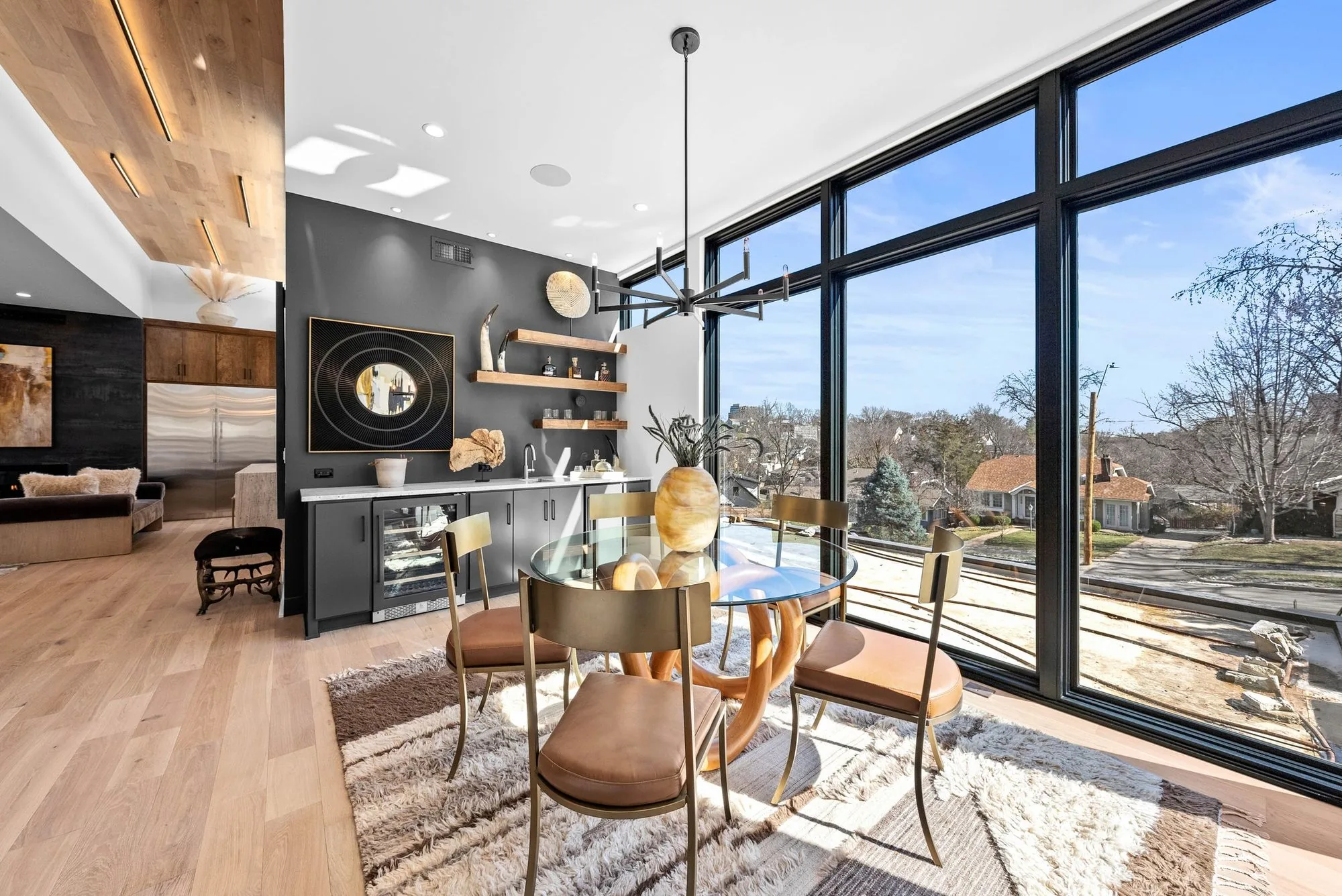 Open living and dining space in a Renew Design Build home with floor to ceiling windows